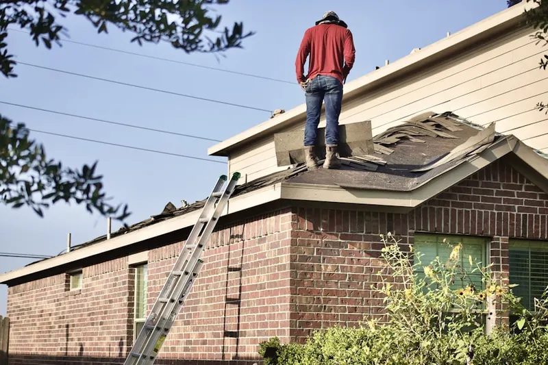 Professional roofer working on a residential roof in Kylawn